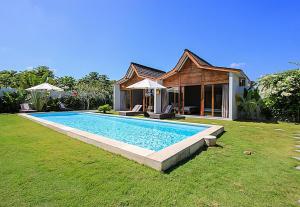 a swimming pool in the yard of a house at Villa Mitsouko by Optimum Bali Villas in Seminyak