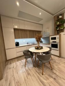 a kitchen with a table and chairs in a room at Cozy apartment close to the city center in Bratislava