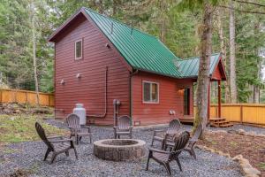 a group of chairs in front of a red cabin at Mt. Rainier Cabin w/hot tub in Ashford