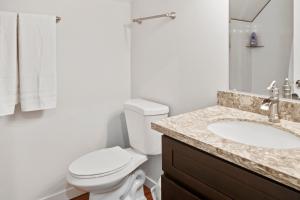 a bathroom with a white toilet and a sink at Mt. Rainier Cabin w/hot tub in Ashford +13 photos