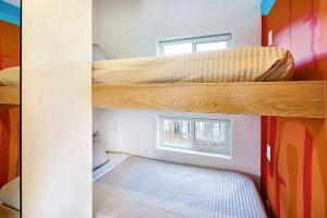 two bunk beds in a room with a window at Downtown Kokopelli West 5 - Newly Remodeled Stylish Studio in Moab