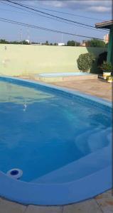 a swimming pool with blue water in a house at Apartamento Mossoró in Mossoró