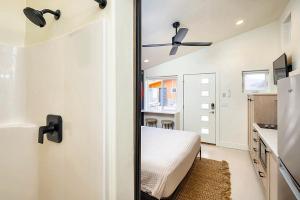 a bedroom with a bed and a door with a mirror at Downtown Kokopelli West 6 - Newly Remodeled Stylish Studio in Moab