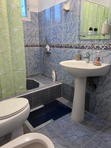 a bathroom with a sink and a toilet at Playa Azul House in Bayahibe