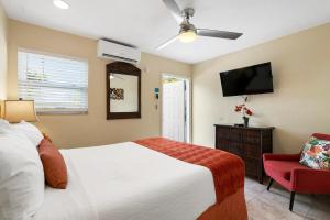 a bedroom with a bed and a flat screen tv at Bay Harbor Lodge in Key Largo