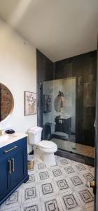 a bathroom with a toilet and a sink and a shower at Speakeasy Suites Sleeps 18 in Nevada City