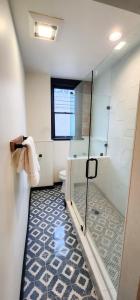 a bathroom with a shower and a glass shower backdoor at Speakeasy Suites Sleeps 18 in Nevada City