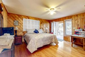 a bedroom with a bed and a ceiling fan at Life's a River in Ellijay