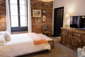 内华达城Speakeasy Queen Suite (Rm 3)的一间带床和平板电视的卧室
