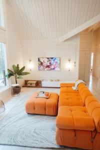a large living room with an orange couch at 70s Retro Retreat Nevada City in Nevada City