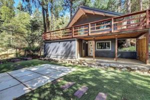 a house with a deck and a yard at 70s Retro Retreat Nevada City in Nevada City