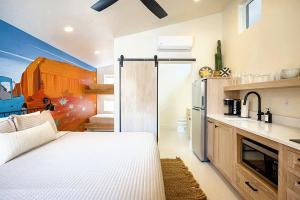 a kitchen with a sliding glass door to a refrigerator at Downtown Kokopelli West 9 - Newly Remodeled Stylish Studio in Moab