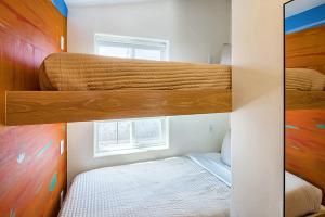 a bedroom with two bunk beds and a window at Downtown Kokopelli West 9 - Newly Remodeled Stylish Studio in Moab