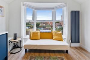 a living room with a couch and a large window at The Buccleuch Luxury Apartments in Kettering