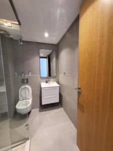 a bathroom with a sink and a toilet and a mirror at Appartement Casablanca in Casablanca