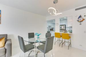a dining room with a glass table and chairs at Hollywood Vacation Rental with Direct Beach Access! in Hollywood