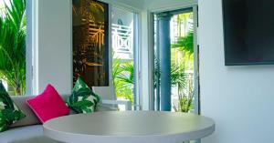 a white coffee table in a room with a window at The Palms Resort in Saint James