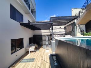 a balcony of a house with a swimming pool at GZ GUEST HOUSE in Cuenca