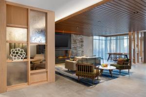 a living room with a couch and a fireplace at Fairfield by Marriott Inn & Suites Indianapolis Plainfield in Plainfield