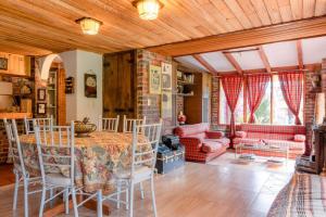 a living room with a table and chairs and a couch at Tu Casa - Hotel Rural in Sopó