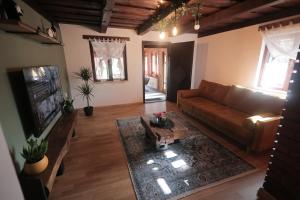 a living room with a couch and a tv at Ruralna kuća za odmor Marija in Novigrad Podravski