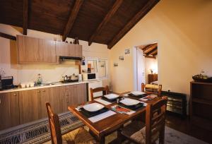 a kitchen and dining room with a wooden table at Sunset Suite - Salamina Island in Salamina