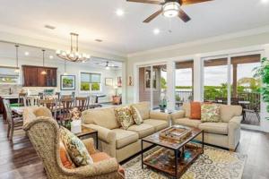 a living room with a couch and chairs and a dining room at Papa's Abode by Brightwild-Huge Home & Pool in Stock Island