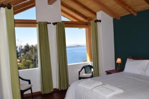 a bedroom with a bed and a view of the ocean at Casa de la Luna - ISLA DEL SOL in Comunidad Yumani
