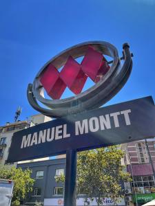 a sign for a manual month with a street sign at Apartamentos City Centro Manuel Montt in Santiago