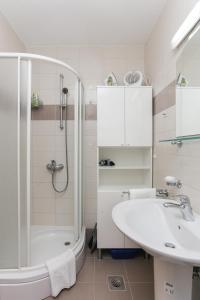 baño blanco con ducha y lavamanos en Apartment Maya, en Dubrovnik
