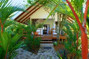 a patio of a house with some palm trees at Casa Kristel - Exquisite Villa Getaway in Puerto Viejo