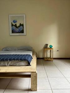 a bedroom with a bed and a picture on the wall at casa ilha bela in Ilhabela