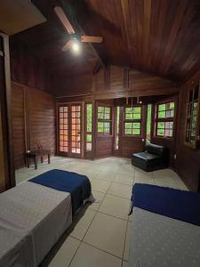 a large room with two beds and a couch at casa ilha bela in Ilhabela