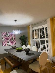 a dining room with a table with chairs and a dining room at Discover Your Home Away From Home Near YYZ Airport in Mississauga