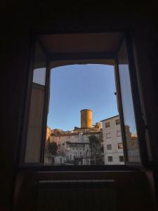 a window with a view of a building at Peperoni House - Sea and Mountain Experience in San Marco Argentano