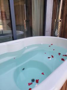a bath tub with some butterflies in it at La Filature 1813 in Wasselonne