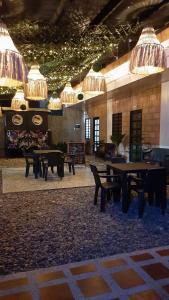 a large room with tables and chairs and chandeliers at Cabañas Mar Caribe in Necoclí