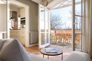 a living room with a large sliding glass door at Antonias Hüs in Midlum +29 photos