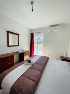 En eller flere senge i et værelse på Coral Cove Comfort Room 1