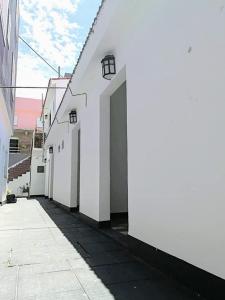 a white building with a door on the side of it at Almirante Brown 49 in Mar de Ajó