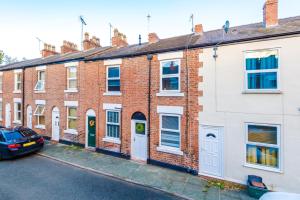 a row of brick houses with a car parked in front at NEW! Spacious 2-bed home in Chester City-Centre by 53 Degrees Property, ideal for Couples & Small groups, Great Location - Sleeps 5 in Chester