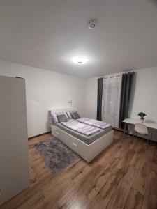 Un dormitorio con una cama y una mesa. en Wohnen am Wasser - Privatzimmer - Sharing Apartment, en Constanza