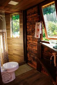 a bathroom with a toilet and a sink at Moradia da Mata in Nilo Peçanha