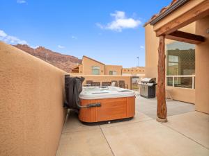 a hot tub on a patio in a house at Rim Village X3 - large patio with private hot tub in Moab