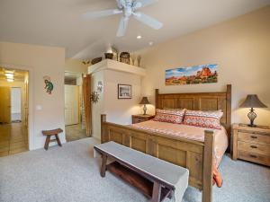 a bedroom with a bed and a ceiling fan at Rim Village X3 - large patio with private hot tub in Moab