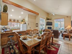 a dining room and living room with a table and chairs at Rim Village X3 - large patio with private hot tub in Moab