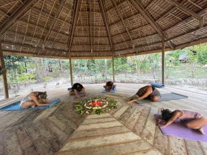 a group of people doing yoga in a pavilion at Harmony Healing Project - Connect With Your Divinity in El Nido