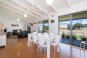 a dining room with a white table and chairs at Ocean Spray Retreat in Port Fairy