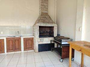 a kitchen with a brick oven in a room at Villa Candida in Encarnación