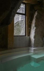 a bathroom with a window and a bath tub at Dimora d'Arte Mariano Pietrini in Barcellona-Pozzo di Gotto